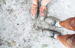 88 days of farm work – Muddy Farm Life 88 days of farm work - Picture of two people standing in wet mud with muddy trainers